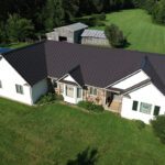 Dark Bronze Standing Seam Roof on a White House